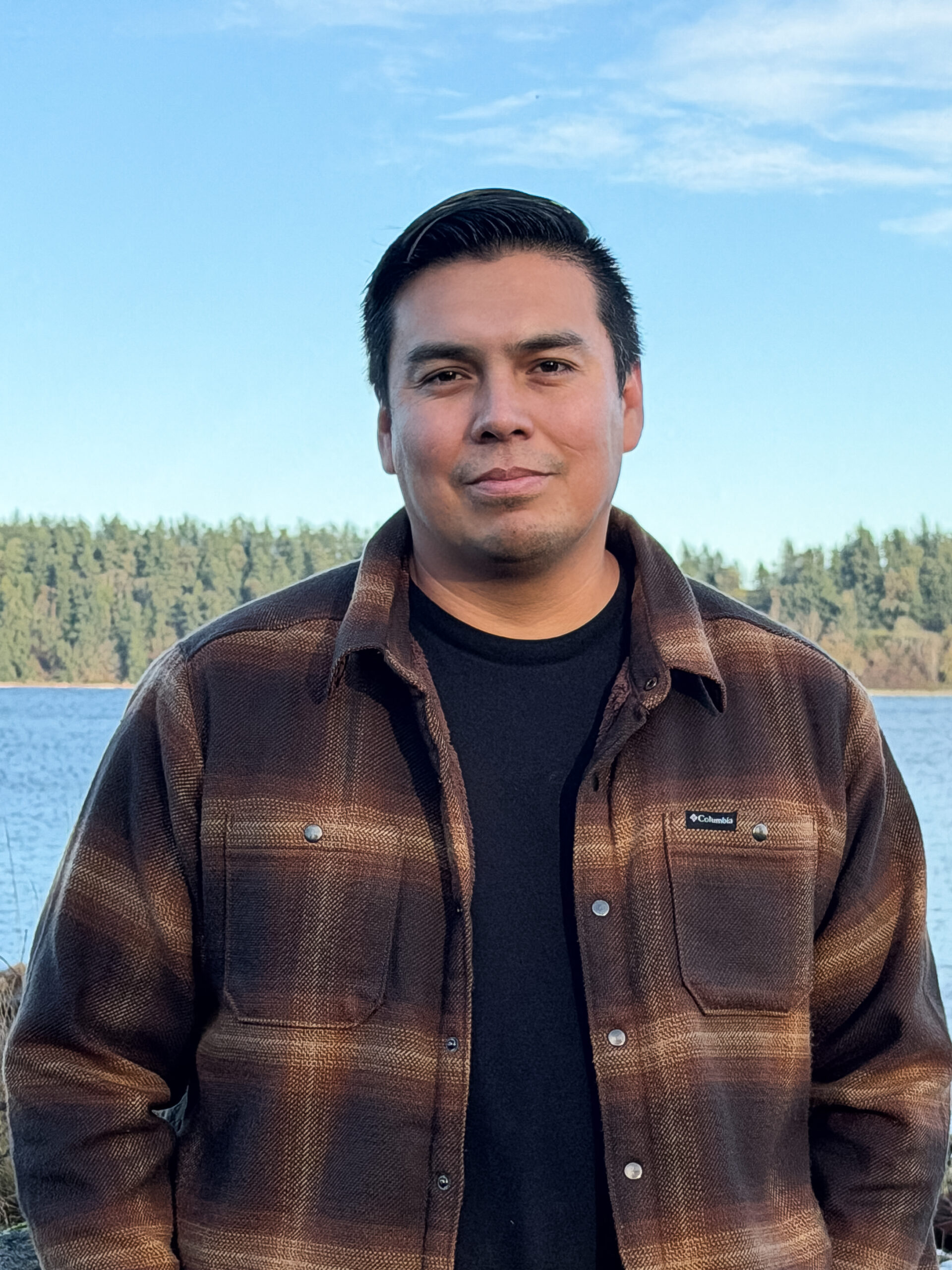 Image of Micah Claxton, president of Yell-Quay-Tza Solutions, standing at the water's edge.